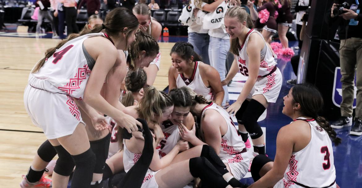 Jubilation broke out as Kara Nixon (middle) was mobbed by her teammates after making a buzzer beating shot to win the Class 2A State Championship Game March 2 at The Alamodome in San Antonio. Nixon’s game-winning basket gave Martins Mill a 44-42 victory over Nocona.